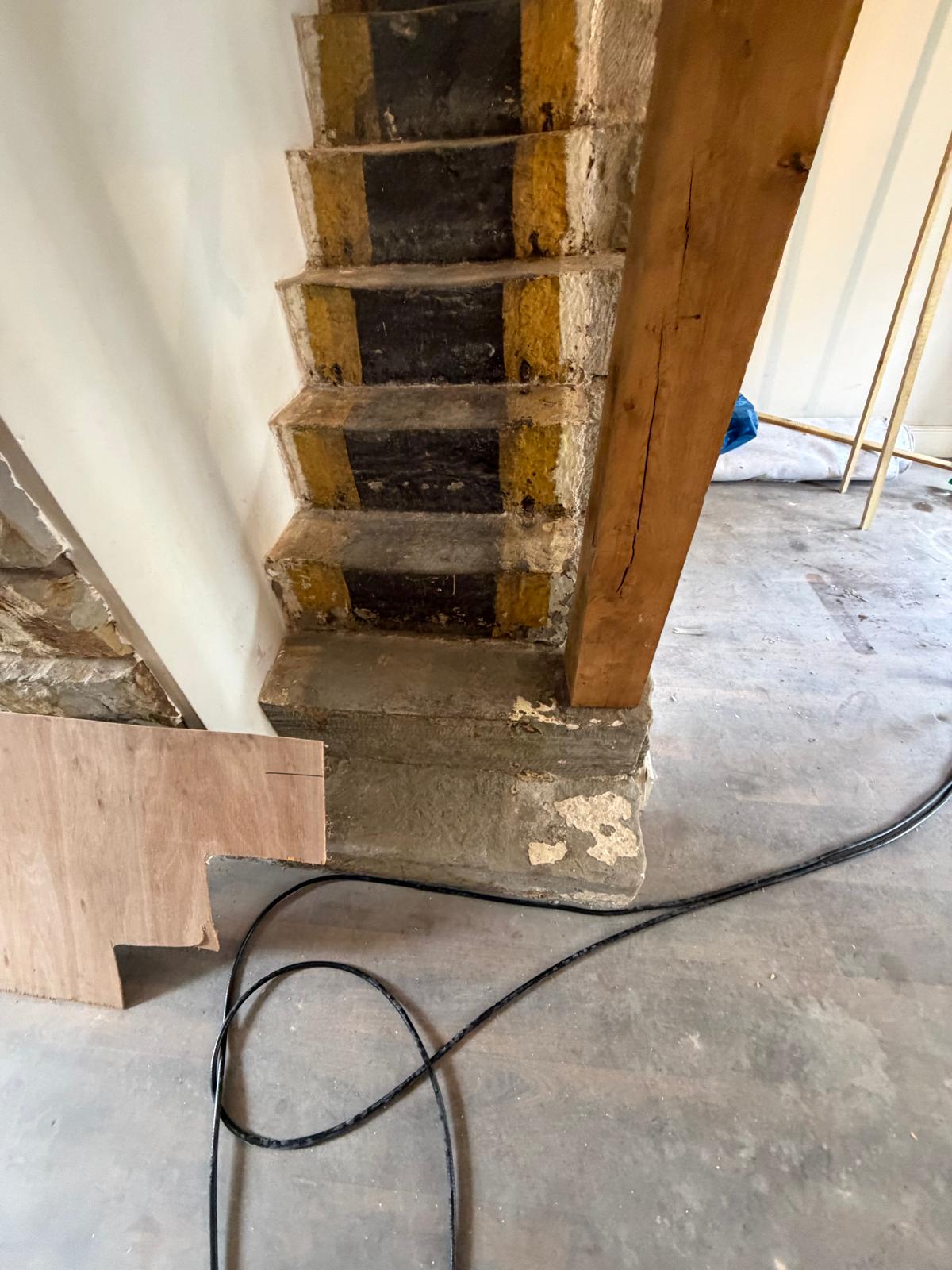 Stone staircase with original timber post exposed