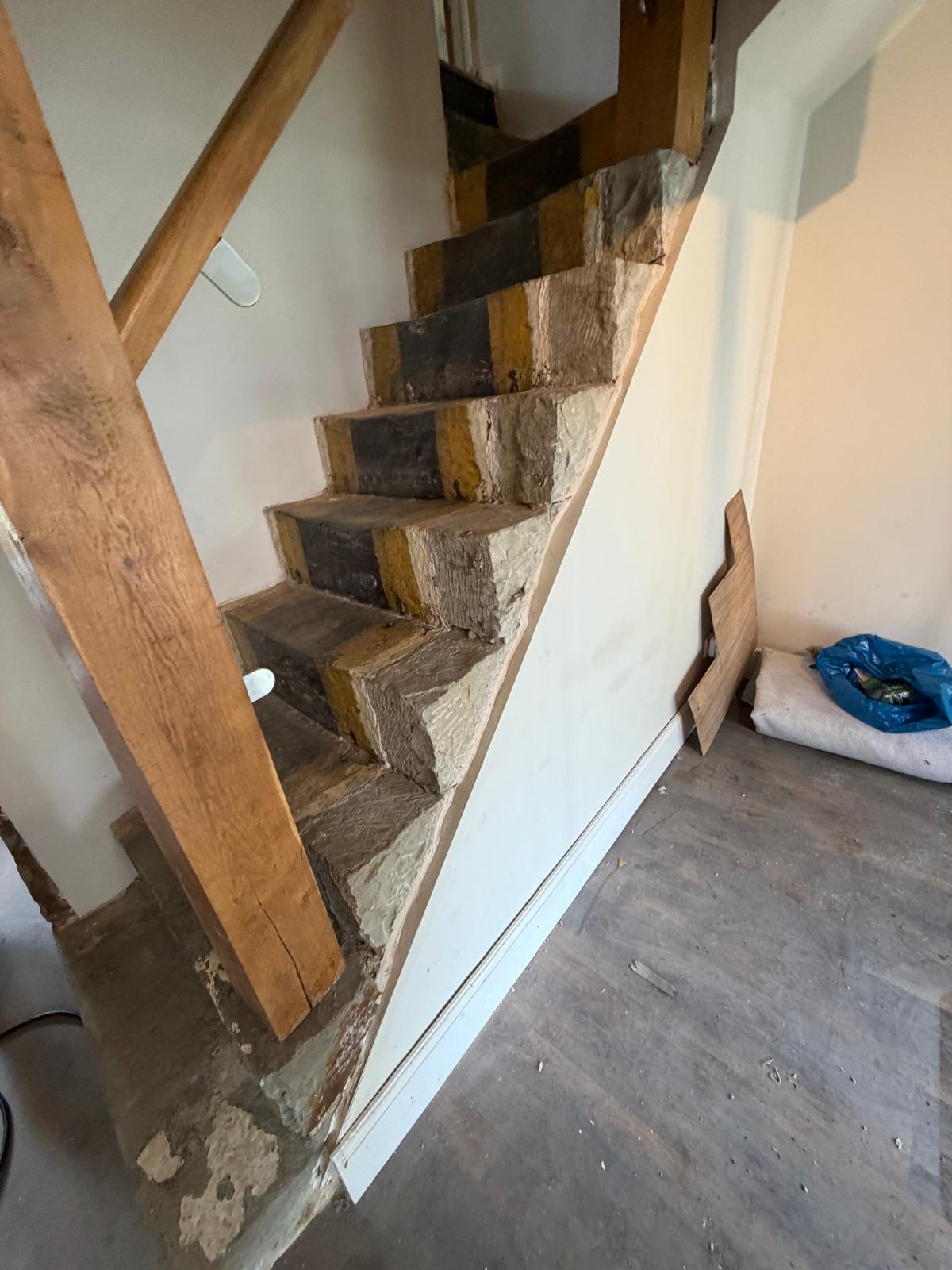 Heritage staircase detail — stone treads and oak stringer