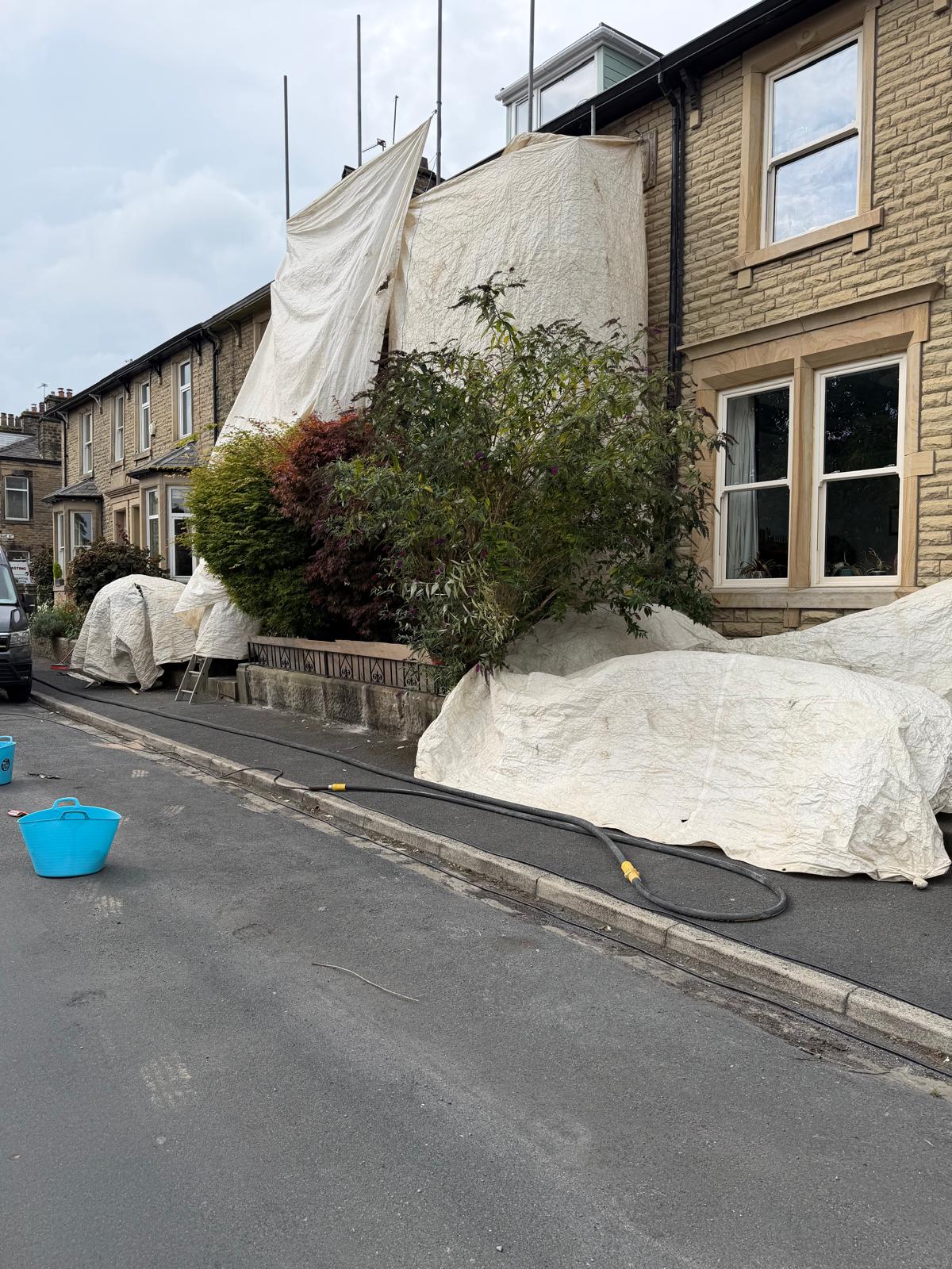 Elevation fully sheeted for containment before blast cleaning
