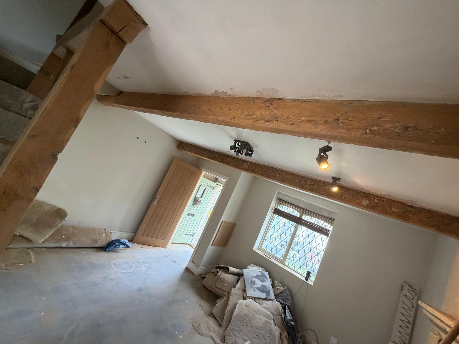 Upper room with exposed oak beams and leaded window