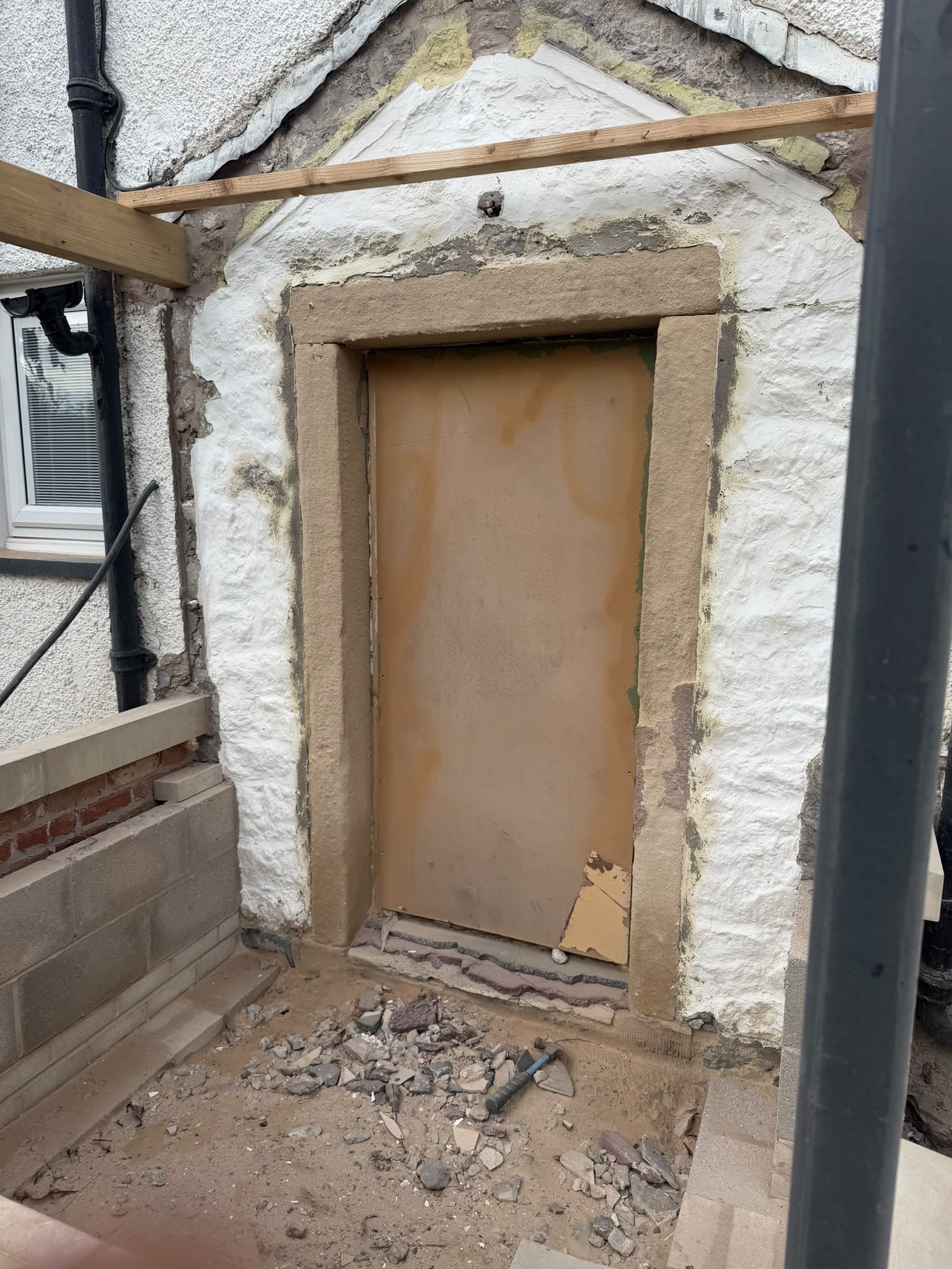 Natural stone doorway revealed after blast cleaning in Clitheroe