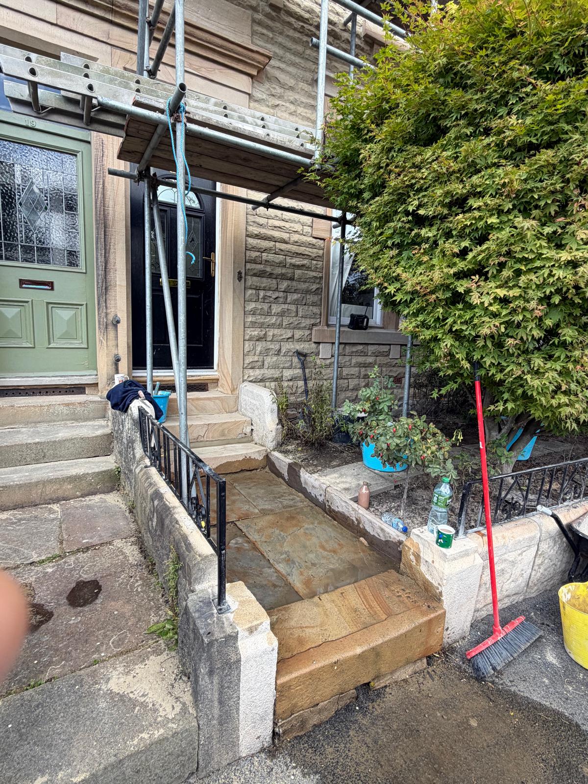 Stone entrance steps and porch prepared for cleaning